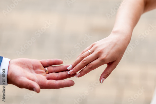 Bride and groom hands drawning to each other