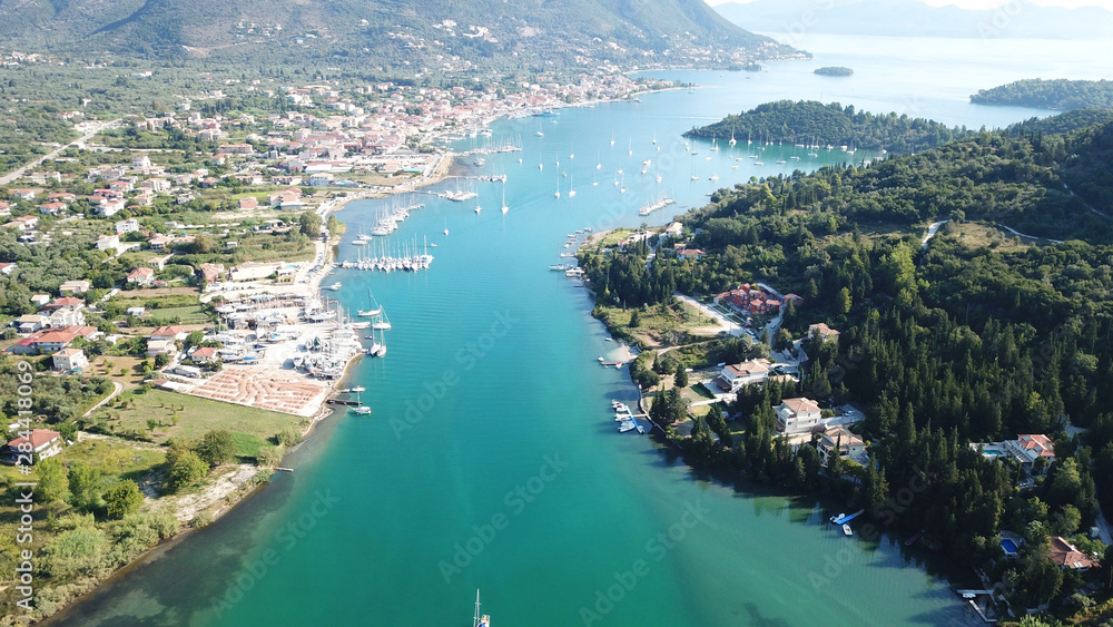 Aerial drone bird's eye view photo of iconic port of Nidry or Nydri a safe harbor for sail boats and famous for trips to Meganisi, Skorpios and other Ionian islands, Leflkada island, Ionian, Greece