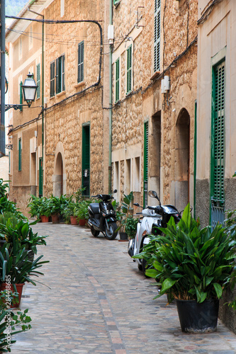 Spain, Balearic Islands, Mallorca, Soller, historical Northwest Coast village town. Stone side alleyway. Motor scooters.