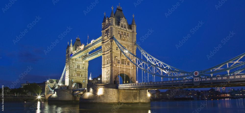 Fototapeta Great Britain, London. The historic Tower Bridge and River Thames at night.