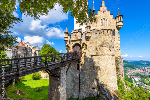 Lichtenstein Castle with bridge, Baden-Wurttemberg, Germany. This fairy tale castle is a landmark of Germany. Front view of Lichtenstein Castle on a cliff. Tourist place in Swabian Alps in summer. photo