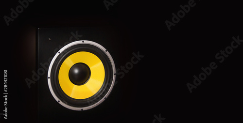 Yellow loudspeaker close on the dark background close up shot