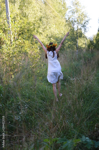 Happy girl is danсing in the nature