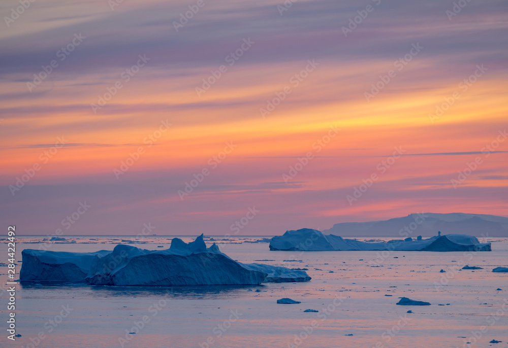 Ilulissat Icefjord also called kangia or Ilulissat Kangerlua, sunset over Disko Bay. The icefjord is listed as UNESCO World Heritage Site.