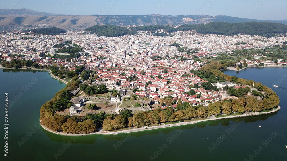 Aerial drone bird's eye view photo of iconic city and castle and mosque of Ioannina surounded by famous lake and mountains of Pindus, Epirus, Greece