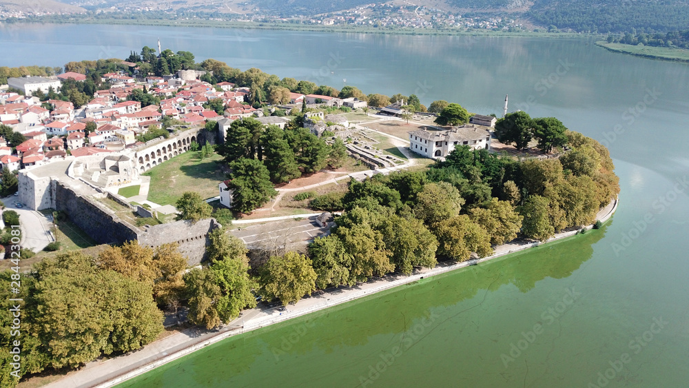 Aerial drone bird's eye view photo of iconic city and castle and mosque of Ioannina surounded by famous lake and mountains of Pindus, Epirus, Greece