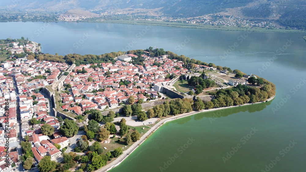 Aerial drone bird's eye panoramic photo of iconic city, castle and mosque of Ioanina surounded by famous lake and mountains of Pindus, Epirus, Greece
