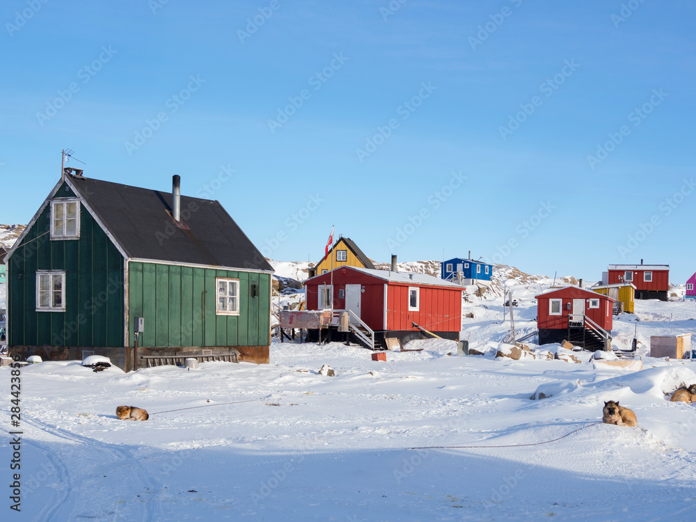 The fishing village Saatut during winter in the Uummannaq fjord system north of the polar circle. Greenland, Denmark. The fishing village Saatut during winter in the Uummannaq fjord system north of the polar circle. Greenland, Denmark.