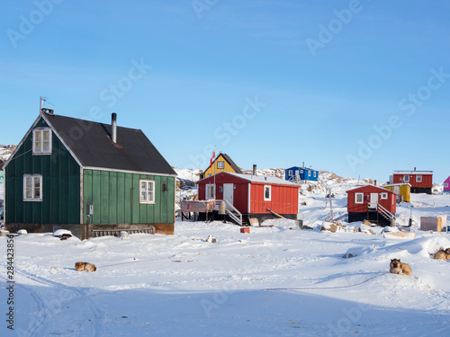 The fishing village Saatut during winter in the Uummannaq fjord system north of the polar circle. Greenland, Denmark.