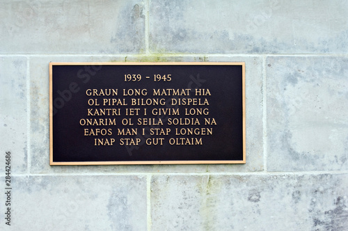 Papua New Guinea, Lae. World War II memorial plaque in Pidgin.