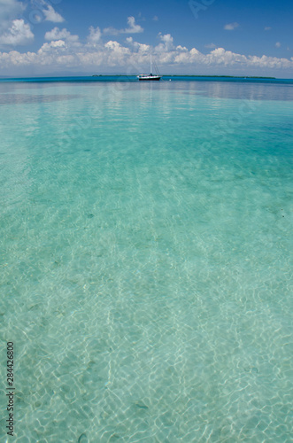 Belize  Southwater Cay. Sailboat in the clear Caribbean sea off the coast of Southwater Cay.