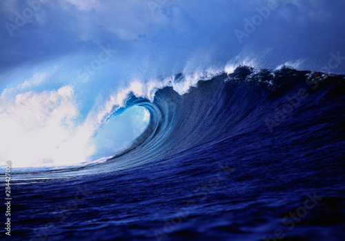 Fiji Islands, Tavarua, Cloudbreak. A stunning wave curl reveals impossible shades of blue, Tavarua, Fiji Islands.