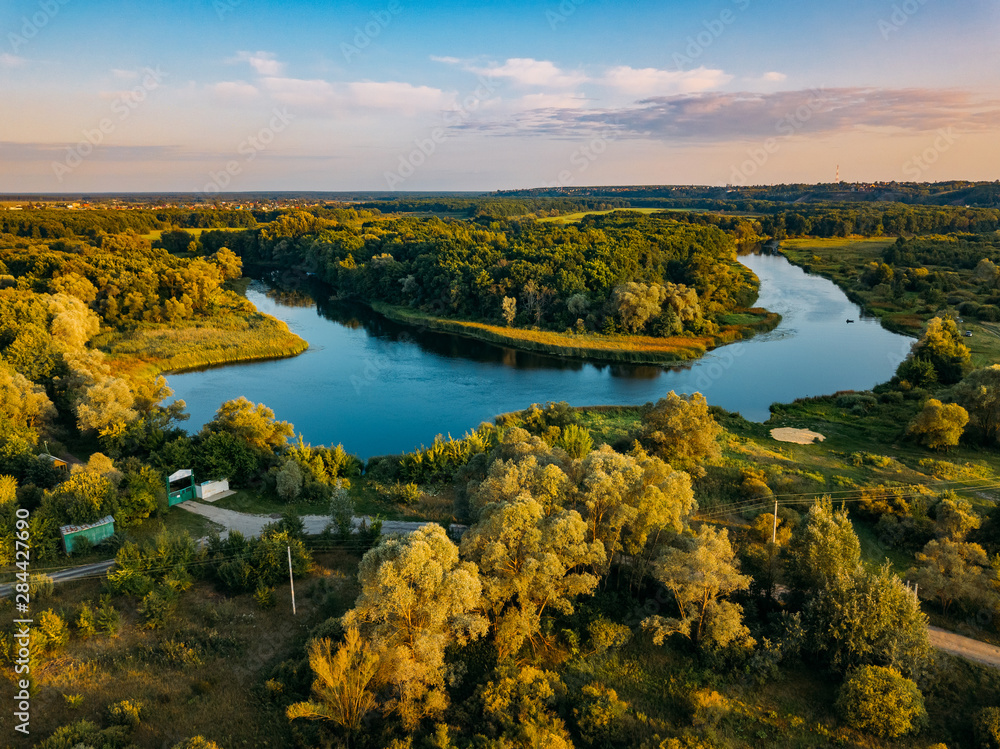 Summer rural landscape, aerial view. Forest and river from drone flight