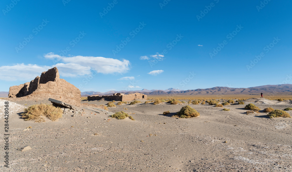 Ruins of buildings for salt processing. Landscape at Salinas Grandes salt flats in the Altiplano, Argentina.