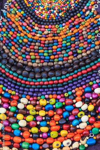 Group of beaded necklaces for sale at an antique market.