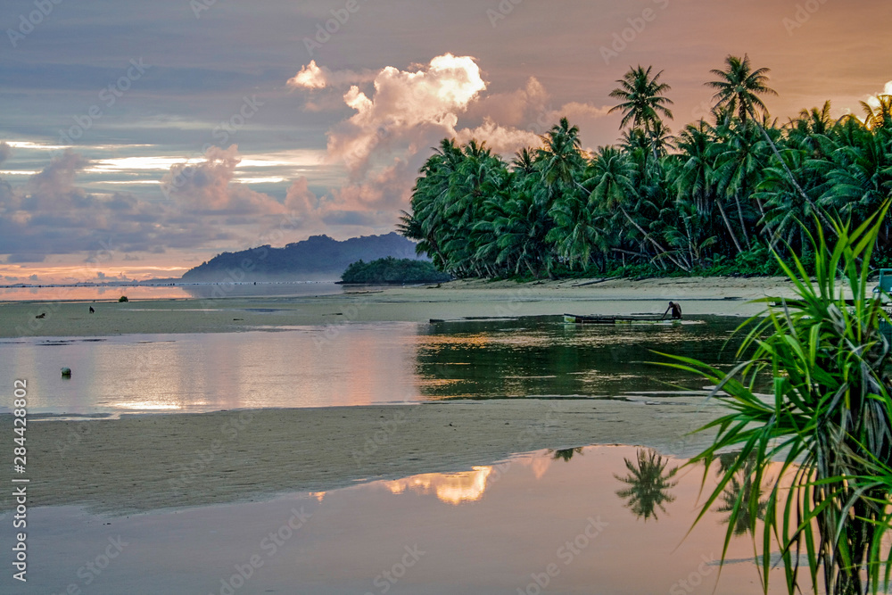 Walung, Kosrae, Micronesia. Local man prepares outrigger canoe at dawn for day of fishing.