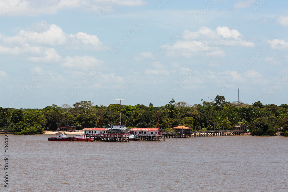 Brazil, Amazon River. Dock and structures on river.
