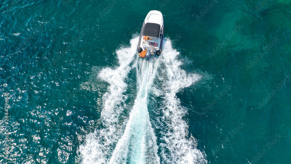 Obraz premium Aerial top view luxury inflatable rib speed boat cruising in Mediterranean emerald sea