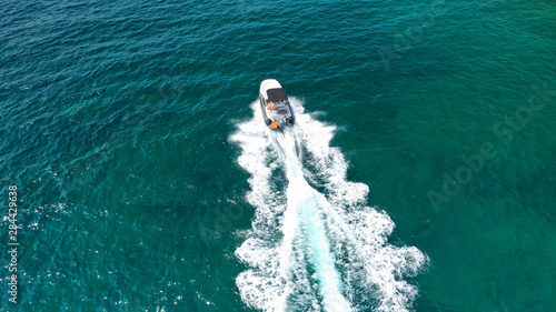 Aerial top view luxury inflatable rib speed boat cruising in Mediterranean emerald sea © aerial-drone