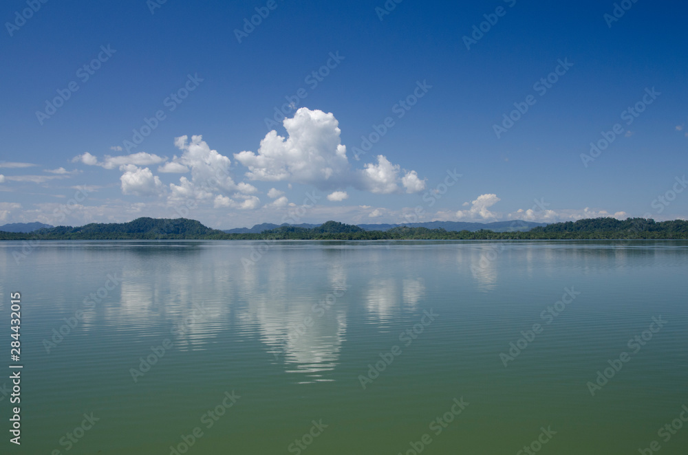 Guatemala, Department of Izabal, Rio Dulce River, El Golfete lake. Calm lake with cloud reflections.