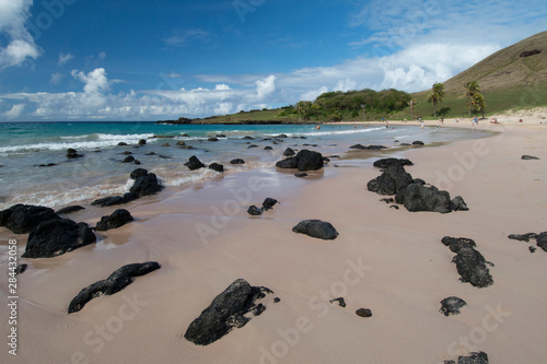 Chile, Easter Island. Rapa Nui National Park. Anakena, important historic beach where the first people to inhabit Easter Island arrived. Lava rock covered scenic beach. photo