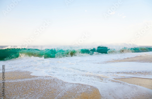 Cabo San Lucas, Baja California Sur, Mexico - Waves splashing onto a beach.