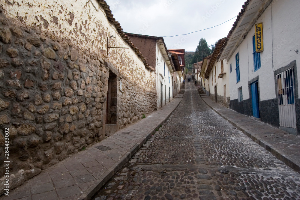 South America - Peru. Old and new building elements along cobblestone street in Cusco.