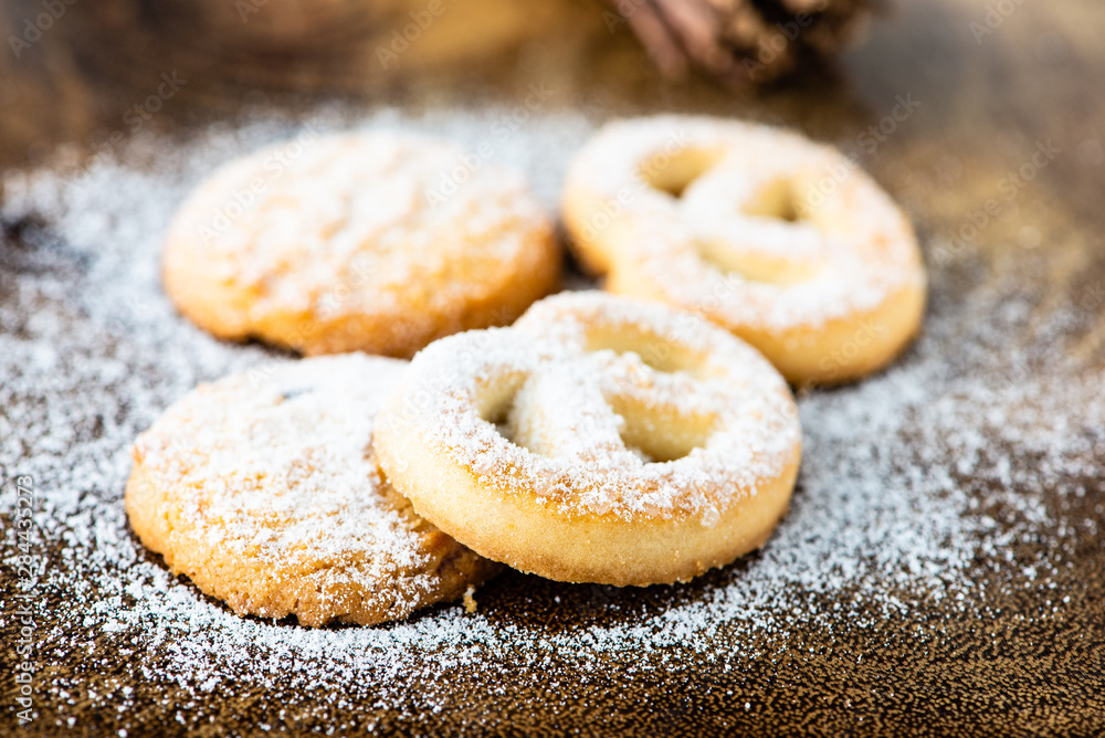 cookies with icing sugar and wood background