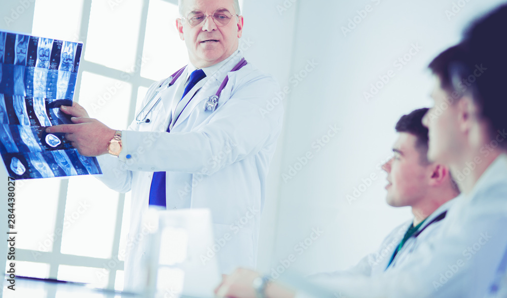 Medical team sitting and discussing at table Medical team sitting and discussing at table