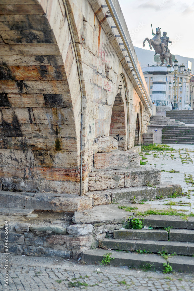 Skopje,Stone Bridge, low angle,towards steps with statue of warrior on horse in background.