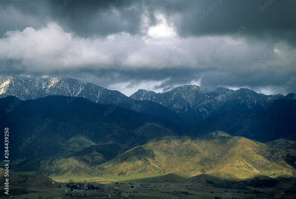 California: San Bernardino Mountains, looking across San Jancinto Mountains at stormy sky and snow-capped mountains