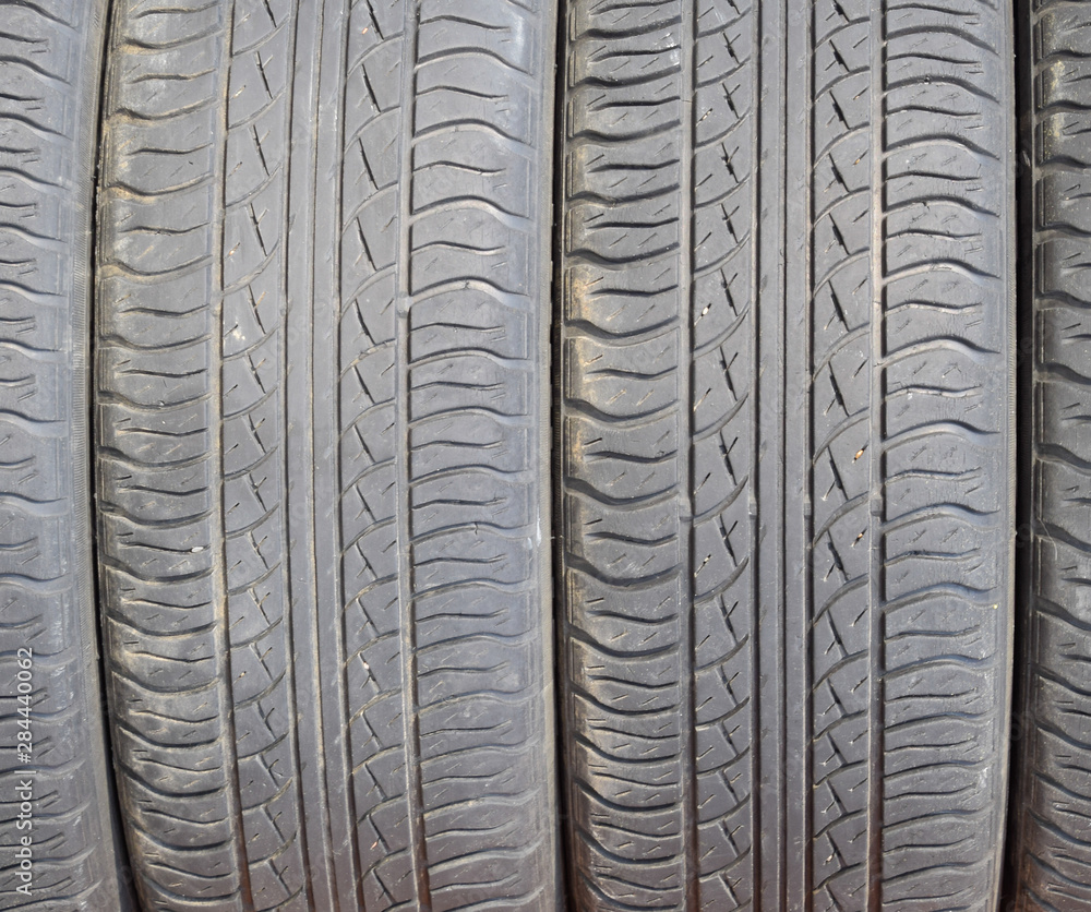 Fototapeta premium The background of the tread pattern of the car wheel. Rubber tir