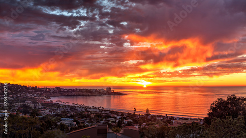Fototapeta Naklejka Na Ścianę i Meble -  USA, California, La Jolla. Panoramic view of sunset over La Jolla Shores and village
