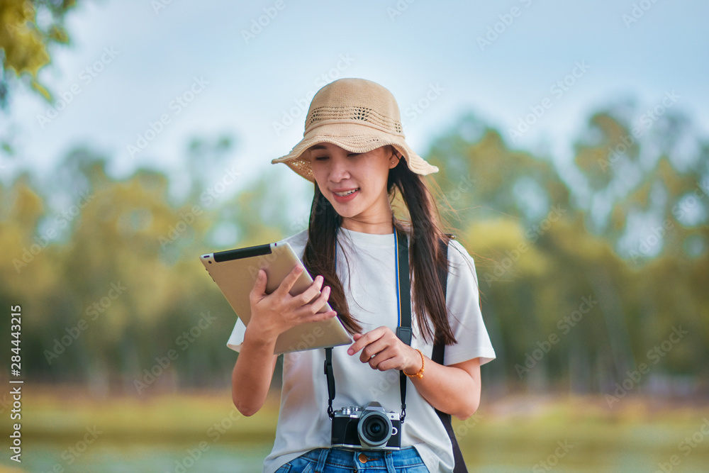 Beauty women holding tablet with camera travel take photo