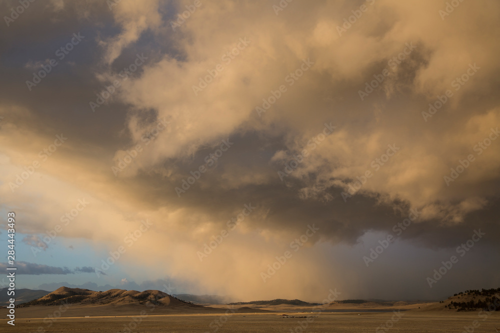 USA, Colorado. Spring storm clouds at sunrise above South Park. 