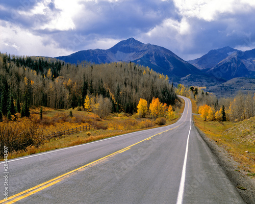 USA, Colorado, San Juan Mountains. A Colorado mountain highway in autumn beckons the driver farther and farther from the world of the known.