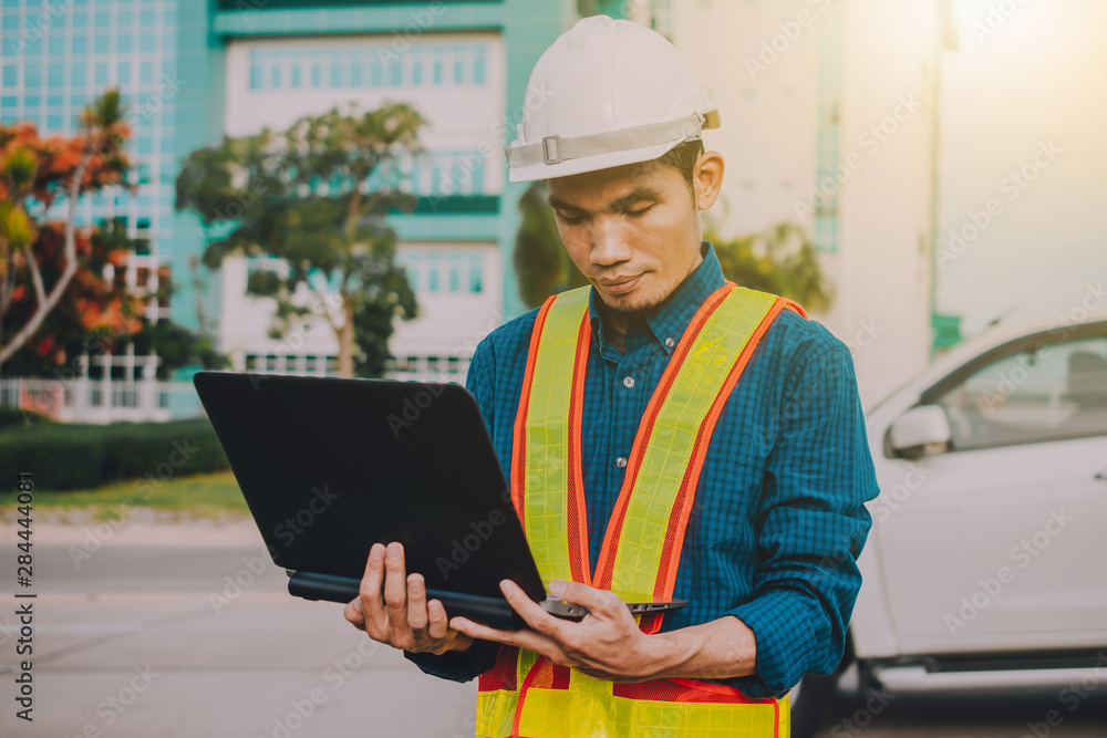 Engineer holding computer working on side technology Engineer holding computer working on side technology