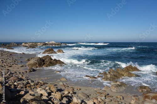 Waves, blue water and rocks along Monterey Peninsula, California coast