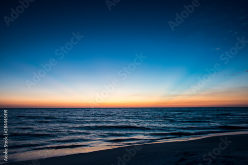 Afterglow of light streaking deep blue sky of sunset scene