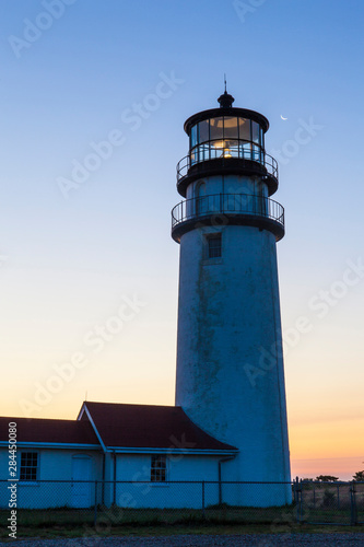 A crescent moon and the Cape Cod Lighthouse, a.k.a. Highland Light, in Truro, Massachusetts. Cape Cod National Seashore.