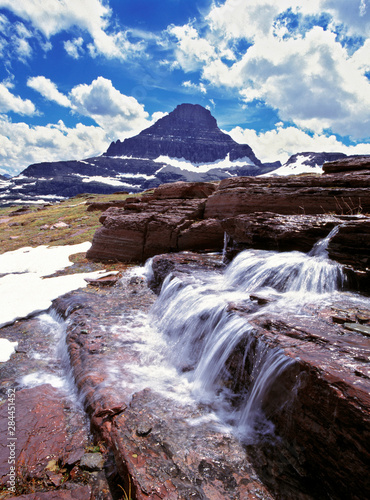 USA, Montana, Glacier NP. A small waterfall flows near the Logan Pass Visitor...