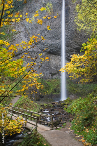 USA, Oregon, Columbia River Gorge. Latourell Falls and wooden bridge over str...