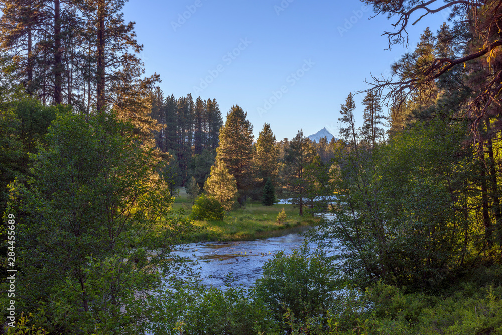 USA, Oregon, Deschutes National Forest, Headwaters of the Metolius River and distant Mount Jefferson at sunset. The Metolius River is a federally designated Wild and Scenic River.