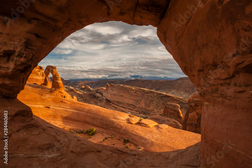 USA, Utah, Arches National Park. Delicate Arch at sunset. through another arch Credit as: Cathy & Gordon Illg / Jaynes Gallery / DanitaDelimont.com