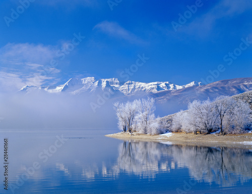Mt. Timpanogas, low clouds, Deer Creek Reservoir and rimmed trees, Wasatch Mountains, Utah. photo