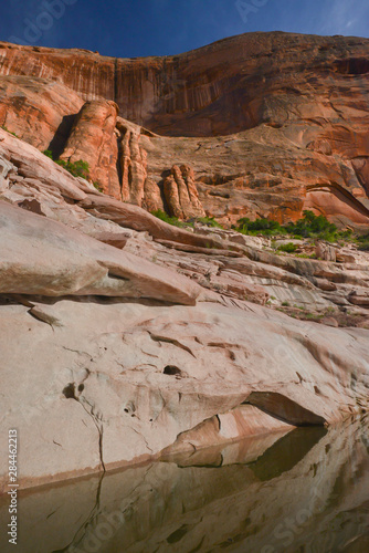 USA, Utah, Glen Canyon national Recreation Area. Canyon walls and reflection of arch formation, Llewelyn Gulch photo