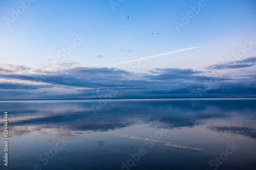 Strait of Juan de Fuca, Sequim, Washington State. Abstract clouds, water reflection, seagulls, over the Puget Sound