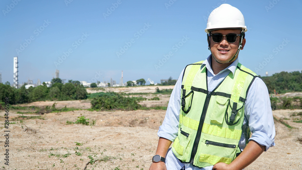 close up front view portrait of male engineer smile at camera on outdoor bright blue sky close up front view portrait of male engineer smile at camera on outdoor bright blue sky