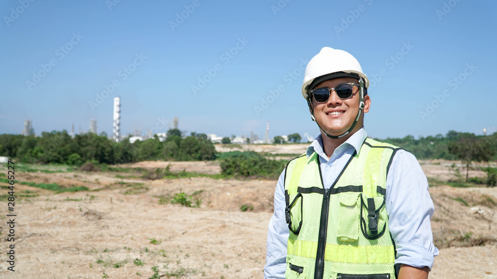 close up front view portrait of male engineer smile at camera on outdoor bright blue sky close up front view portrait of male engineer smile at camera on outdoor bright blue sky