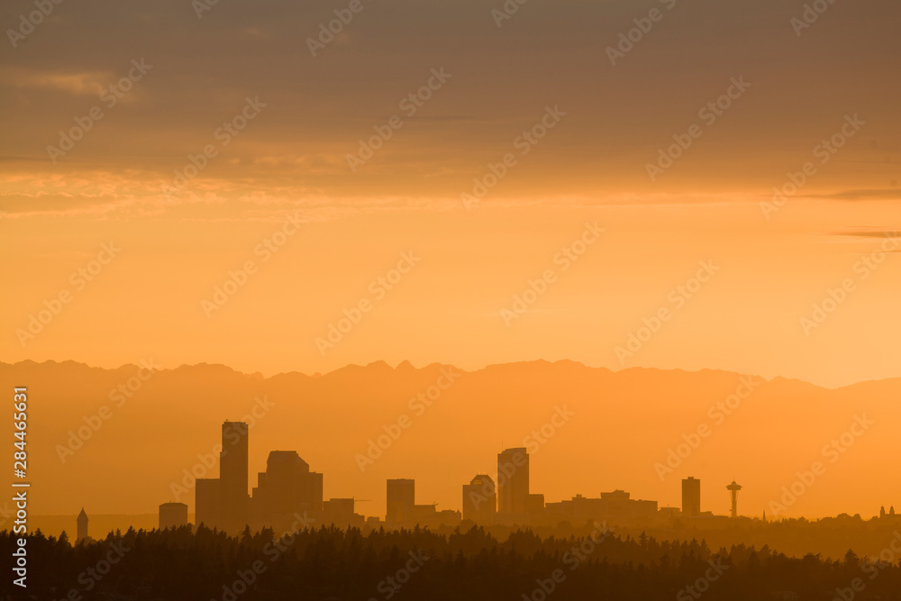 USA, Washington State, Seattle skyline and Olympic Mountains viewed from Bellevue at sunset.